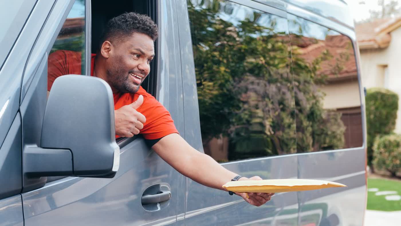 Field sales rep handing over an order from a delivery van
